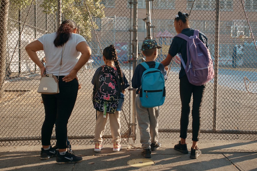 Damien Salinas, 5 years old, center right, arrives to school on Thursday, Sept. 7, 2023, in New York. Damien attends his first day of school in New York City after his family emigrated from Ecuador in June. Damien and her family have been living in a room at the historic Roosevelt Hotel, converted into a city-run shelter for newly arrived migrant families hoping to find work, a new home and a better life for their children. (AP Photo/Andres Kudacki)