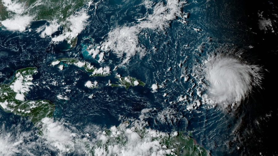 This satellite image provided by the National Oceanographic and Atmospheric Administration shows Hurricane Lee, right, in the Atlantic Ocean on Friday, Sept. 8, 2023, at 4:50 p.m. EDT. Lee is rewriting old rules of meteorology, leaving experts astonished at how rapidly it grew into a goliath Category 5 hurricane. (NOAA via AP)