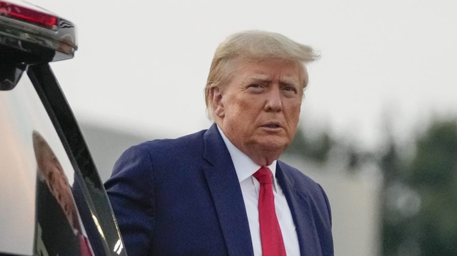 FILE - Former President Donald Trump walks to speak with reporters before departure from Hartsfield-Jackson Atlanta International Airport, Thursday, Aug. 24, 2023, in Atlanta. A judge on Friday, Sept. 8, is expected to release the full report compiled by a special grand jury that helped an investigation by the Georgia prosecutor who ultimately indicted Trump and 18 others. (AP Photo/Alex Brandon, File)