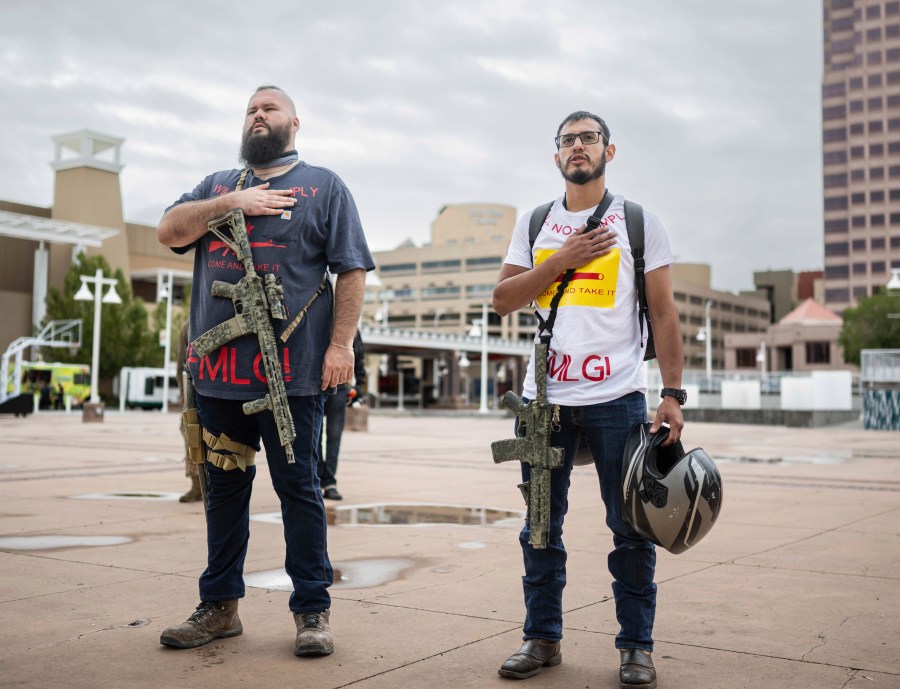 Demonstrators carry their assault rifles to a Second Amendment protest in response to Gov. Michelle Lujan Grisham's recent public health order suspending the conceal and open carry of guns in and around Albuquerque for 30-days, Tuesday, Sept. 12, 2023, in Albuquerque, N.M. (AP Photo/Roberto E. Rosales)