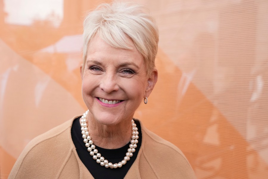 Cindy McCain smiles as she arrives at an event.