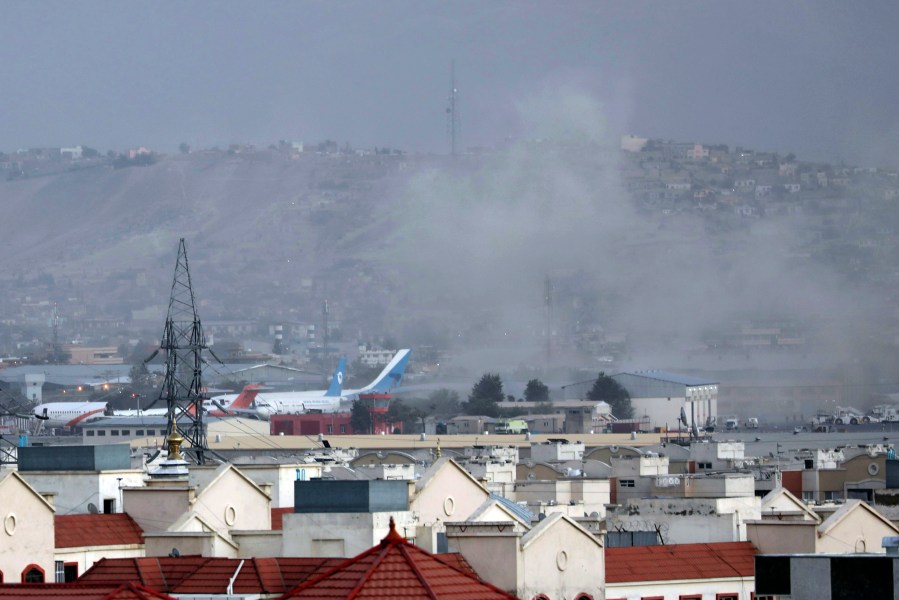 FILE - Smoke rises from a deadly explosion outside the airport in Kabul, Afghanistan, Aug. 26, 2021. The Pentagon’s Central Command has decided to interview roughly two dozen service members who were at the Kabul airport when suicide bombers attacked during the 2021 Afghanistan withdrawal but weren’t included in the military’s initial investigation. (AP Photo/Wali Sabawoon, File)