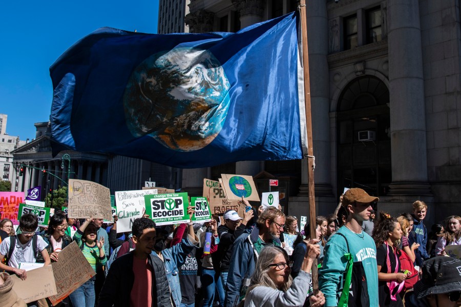 FILE - Activists gather and walk through lower Manhattan for the Global Climate Strike protests, Sept. 23, 2022, in New York. The annual Climate Week, which coincides with the U.N. General Assembly, kicks off Sunday, Sept. 17, 2023, with tens of thousands of people expected in the “March to End Fossil Fuels” Manhattan rally, one of hundreds of worldwide protests. (AP Photo/Brittainy Newman, File)