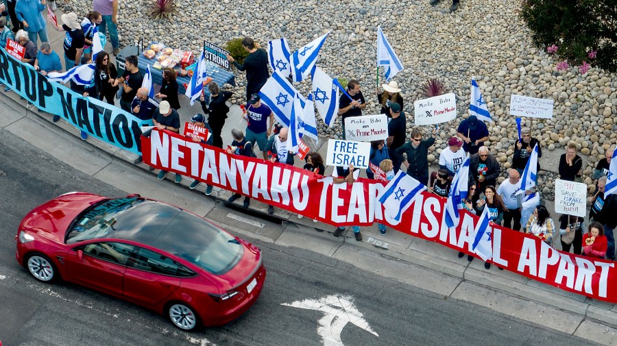 Protesters rally outside Tesla's Fremont, Calif., factory as Israeli Prime Minister Benjamin Netanyahu plans a visit with businessman Elon Musk on Monday, Sept. 18, 2023. (AP Photo/Noah Berger)