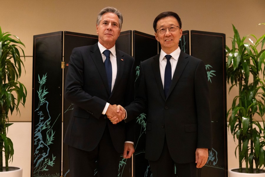 Secretary of State Antony Blinken and Chinese Vice President Han Zheng shake hands while posing for photos, Monday, Sept. 18, 2023, in New York. (AP Photo/Julia Nikhinson, Pool)