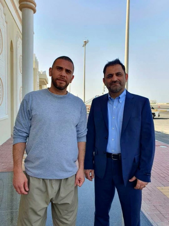 In this photo released by Nour News on Monday, Sept. 18, 2023, Iranians Reza Sarhangpour Kafrani, right, and Mehrdad Moein Ansari pose at Doha airport in Qatar after being released from prison in the United States in a prisoner swap with Iran. Officials said five prisoners sought by the U.S. in a trade with Iran flew out of Tehran on Monday, part of a deal that saw nearly $6 billion in Iranian assets unfrozen. (Nour News via AP)