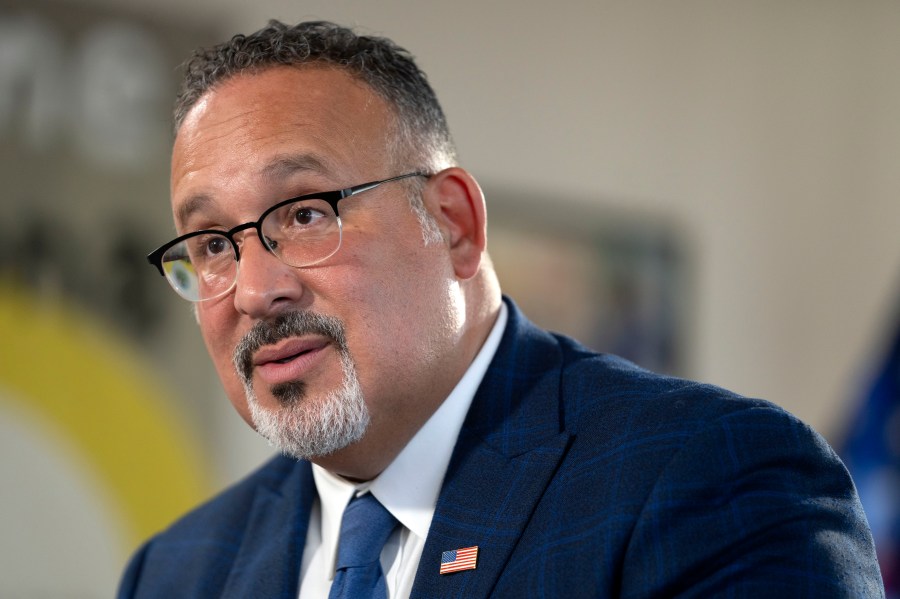 Education Secretary Miguel Cardona speaks during an interview with The Associated Press in his office at the Department of Education, Wednesday, Sept. 20, 2023 in Washington. (AP Photo/Mark Schiefelbein)