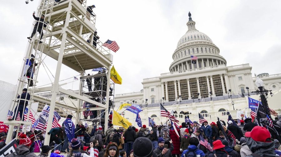 FILE - Violent insurrectionists loyal to President Donald Trump breach the U.S. Capitol in Washington, Jan. 6, 2021. A California man whom prosecutors say was fixated on arresting Democratic leaders and training for combat with paintball fights after the 2020 presidential election was sentenced on Tuesday, Sept. 26, 2023, to more than four years in prison for his role in the U.S. Capitol riot. Edward Badalian planned for weeks before he and a friend traveled from Los Angeles to Washington, D.C., and joined a mob in storming the Capitol on Jan. 6, 2021, according to prosecutors. (AP Photo/John Minchillo, File)