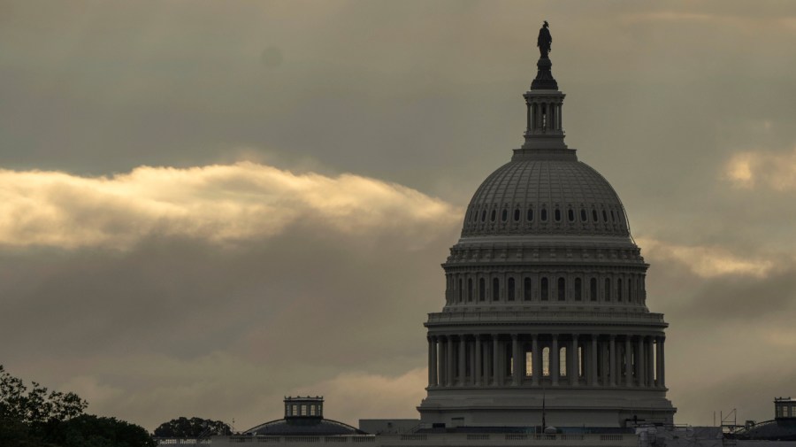 The sun rises through cloudy skies behind the U.S. Capitol in Washington, Monday, Sept. 11, 2023.