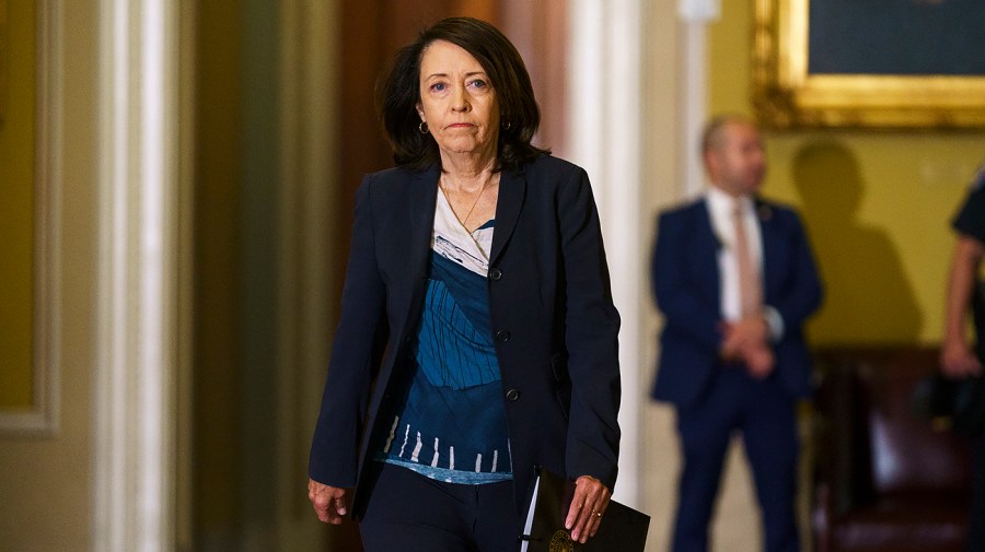 Senator Maria Cantwell walks through the Capitol.