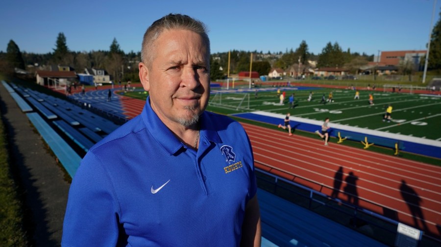 File - Joe Kennedy, a former assistant football coach at Bremerton High School in Bremerton, Wash., poses for a photo March 9, 2022, at the school's football field.