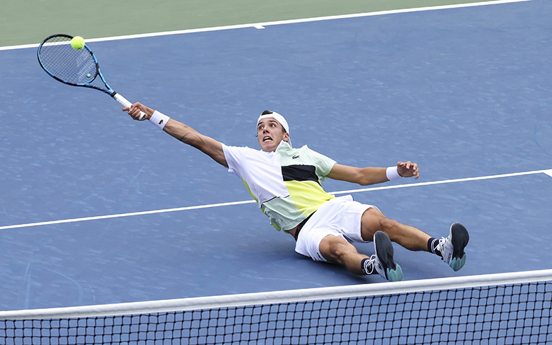 Arthur Cazaux, of France, falls to the ground as he returns a shot to Andrey Rublev, of Russia