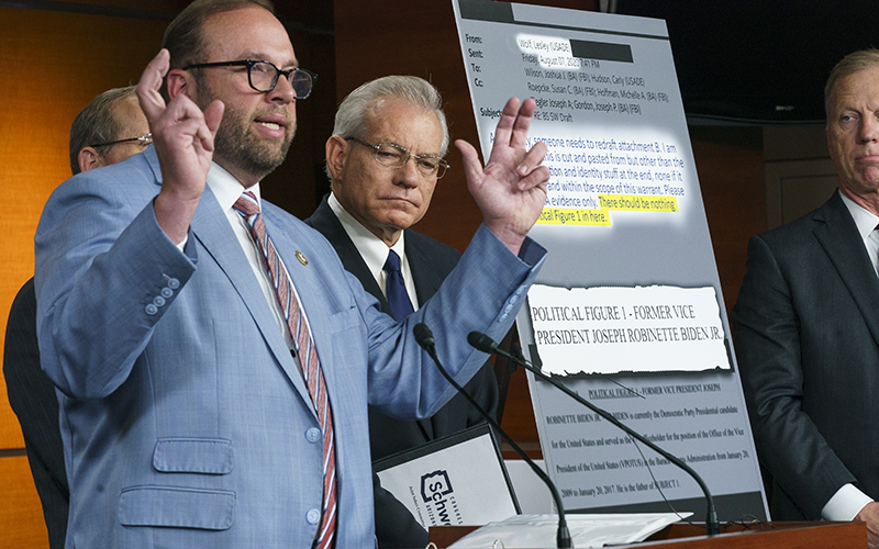 House Ways and Means Committee Chairman Jason Smith (R-Mo.) speaks to reporters. Behind him is a poster displaying the emails that he is talking about, with certain passages highlighted, but much of it is difficult to make out. Lower on the poster are the words "POLITICAL FIGURE 1 - FORMER VICE PRESIDENT JOSEPH ROBINETTE BIDEN JR."