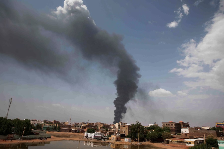 FILE - Smoke rises over Khartoum, Sudan, on June 8, 2023, as fighting between the Sudanese army and paramilitary Rapid Support Forces continues. Four Western countries have floated a proposal on Wednesday Oct. 4, 2023 for the U.N.'s top human rights body to appoint a team of experts to monitor and report on abuses and rights violations in war-wracked Sudan. (AP Photo, File)