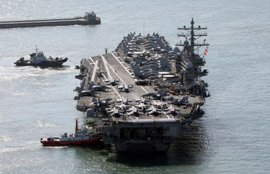 U.S. nuclear-powered aircraft carrier USS Ronald Reagan is escorted as it arrives in Busan, South Korea, Thursday, Oct. 12, 2023. (Kang Duck-chul/Yonhap via AP)