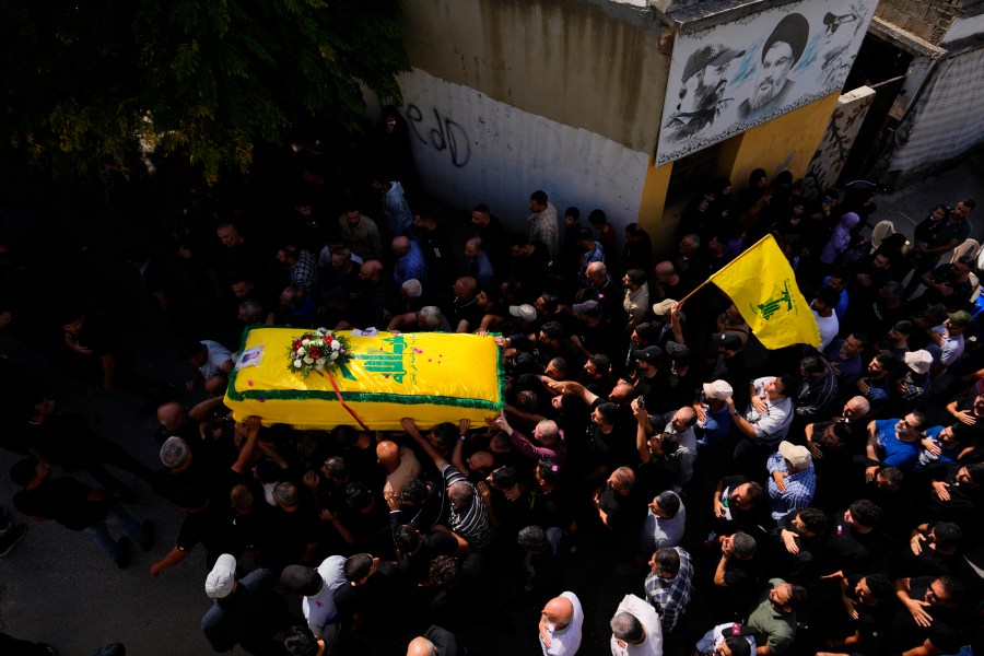 People carry the coffin of Hezbollah fighter, Bilal Nemr Rmeiti, who was killed by Israeli shelling, during his funeral procession in Majadel village, south Lebanon, Sunday, Oct. 22, 2023. (AP Photo/Hassan Ammar)