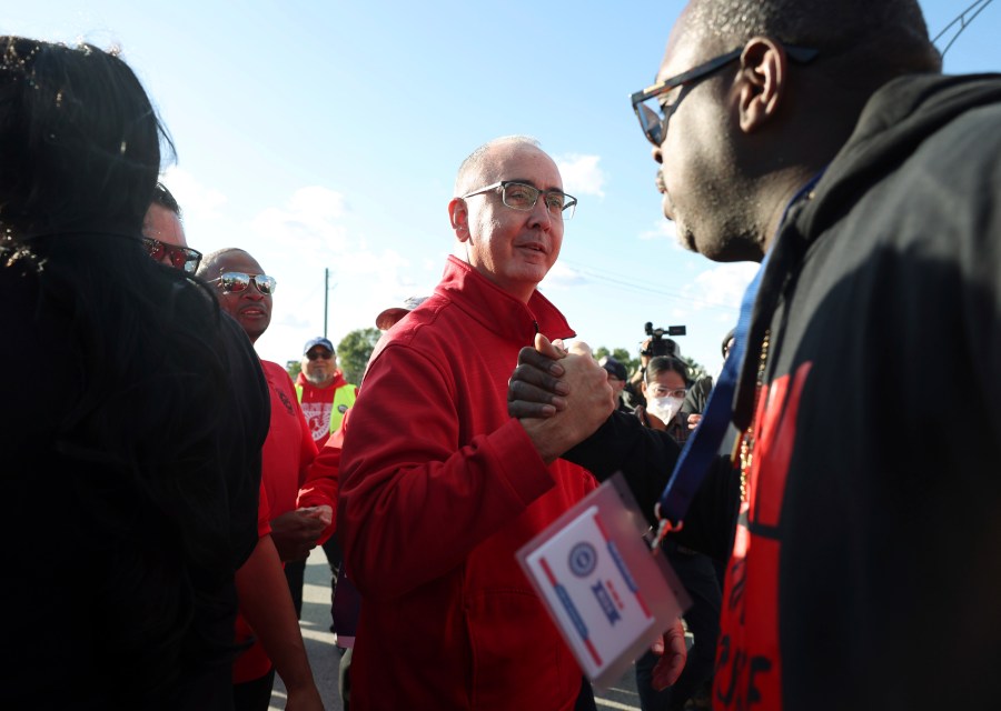 File - United Auto Workers President Shawn Fain, center, visits striking UAW Local 551 workers outside a Ford assembly center on South Burley Avenue on Oct. 7, 2023, in Chicago. Throughout its 5-week-old strikes against Detroit’s automakers, the United Auto Workers union has cast an emphatically combative stance, reflecting the style of Fain, its pugnacious leader. (John J. Kim /Chicago Tribune via AP, File)