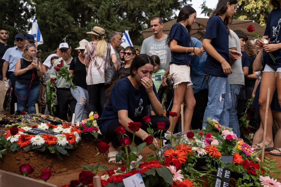 Mourners attend the funeral of Dana Bachar and her son Carmel , at Gan Shlomo cemetery, central Israel, Tuesday, Oct. 24, 2023. Carmel Bachar, 15-year-old and his mother Dana lived in kibbutz Be'eri, a small community with a little more than 1,000 people, that was one of more than 20 towns and villages ambushed on Oct. 7 as part of a surprise attack by Hamas militants against Israel where dozens were killed.(AP Photo/Petros Giannakouris)