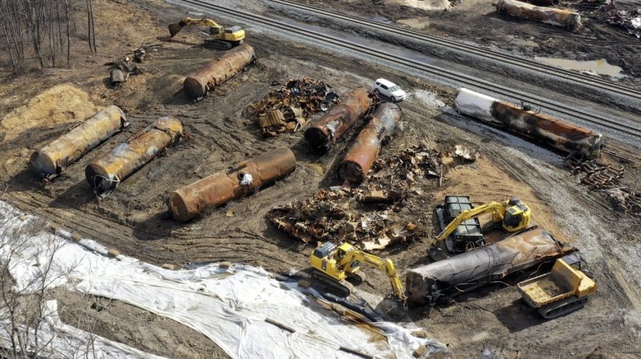 FILE - Cleanup continues, Feb. 24, 2023, at the site of a Norfolk Southern freight train derailment that happened on Feb. 3 in East Palestine, Ohio. The costs related to the East Palestine derailment continue to grow to reach $966 million for Norfolk Southern, but the railroad's service is improving and its insurance companies have started to pay their share of the cost of the crash in eastern Ohio early this year. (AP Photo/Matt Freed, File)