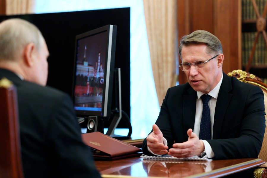 FILE - Russian President Vladimir Putin, left, meets with Health Minister Mikhail Murashko in Moscow, Russia on July 12, 2023. In the span of three decades, Russia went from having some of the world's least-restrictive abortion laws to being what officials call a bulwark of “traditional values,” with Murashko condemning women for prioritizing careers over childbearing. (Alexander Kazakov, Sputnik, Kremlin Pool Photo via AP, File)