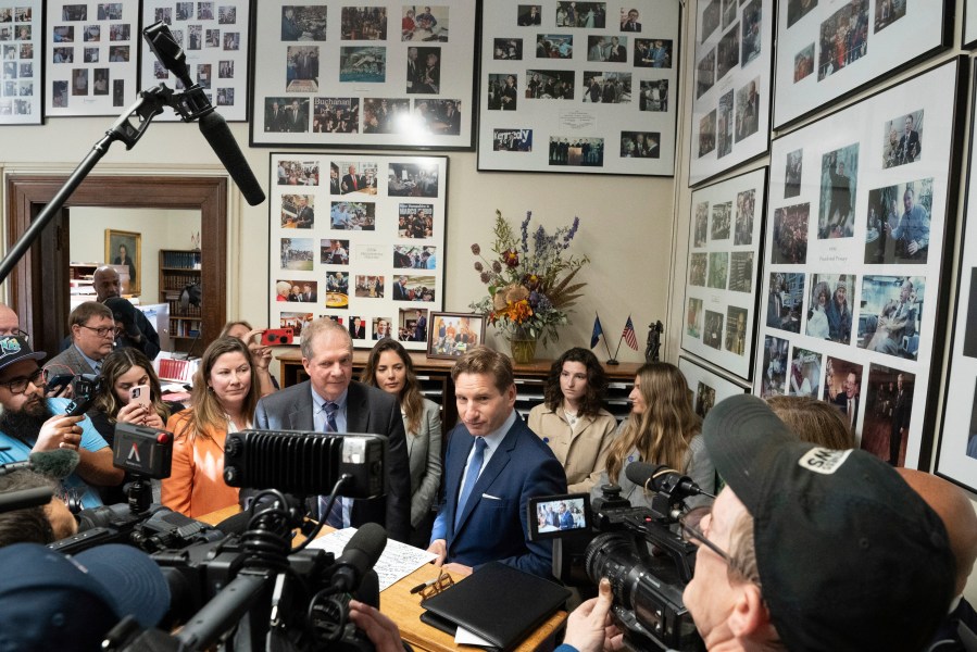 With the New Hampshire Secretary of State David Scanlan at his side, Dean Phillips signed a declaration of candidacy to run for the New Hampshire presidential primary Friday, Oct. 27, 2023 Concord, Minn. (Glen Stubbe/Star Tribune via AP)