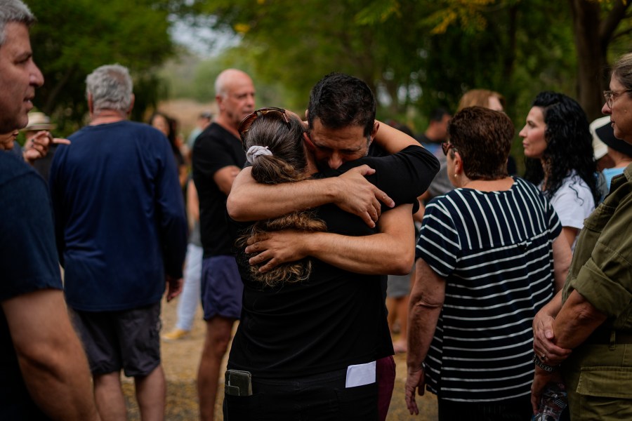 Friends and relatives of Roi Popplewell mourn during his funeral at Kibbutz Yagur near Haifa, northern Israel, Friday, Oct. 27, 2023. (AP Photo/Ariel Schalit)