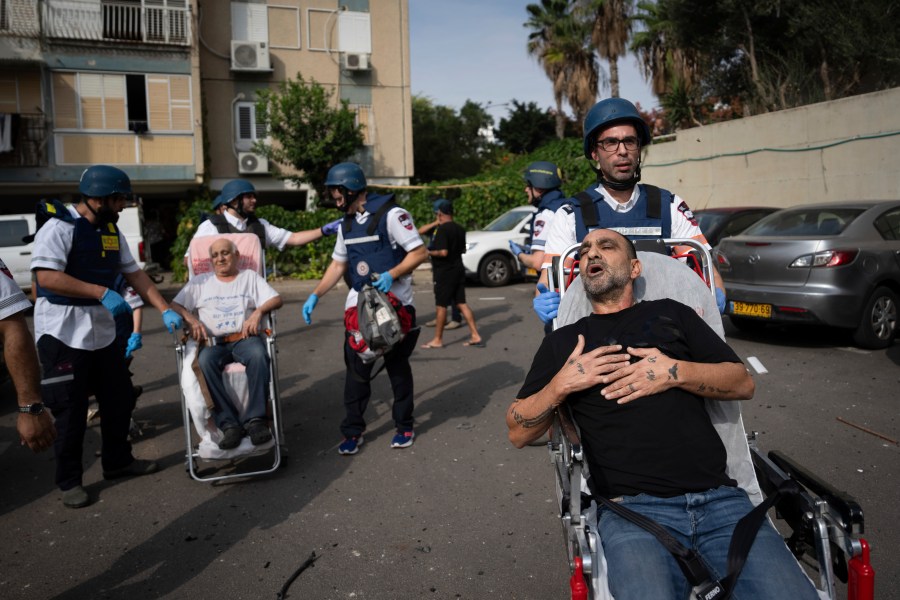 Paramedics evacuate wounded Israelis from a building struck by a rocket fired from Gaza, in Tel Aviv, Israel, Friday, Oct. 27, 2023. (AP Photo/Oded Balilty)