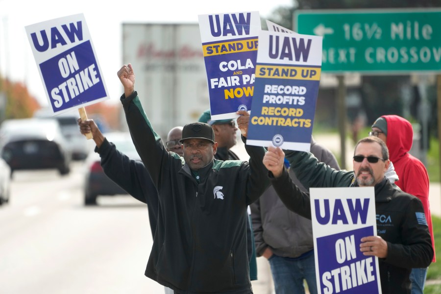 FILE - United Auto Workers members walk the picket line during a strike at the Stellantis Sterling Heights Assembly Plant, in Sterling Heights, Mich., Monday, Oct. 23, 2023. Jeep maker Stellantis has reached a tentative contract agreement with the United Auto Workers union that follows a template set earlier this week by Ford, two people with knowledge of the negotiations said Saturday, Oct. 28, 2023. (AP Photo/Paul Sancya, File)