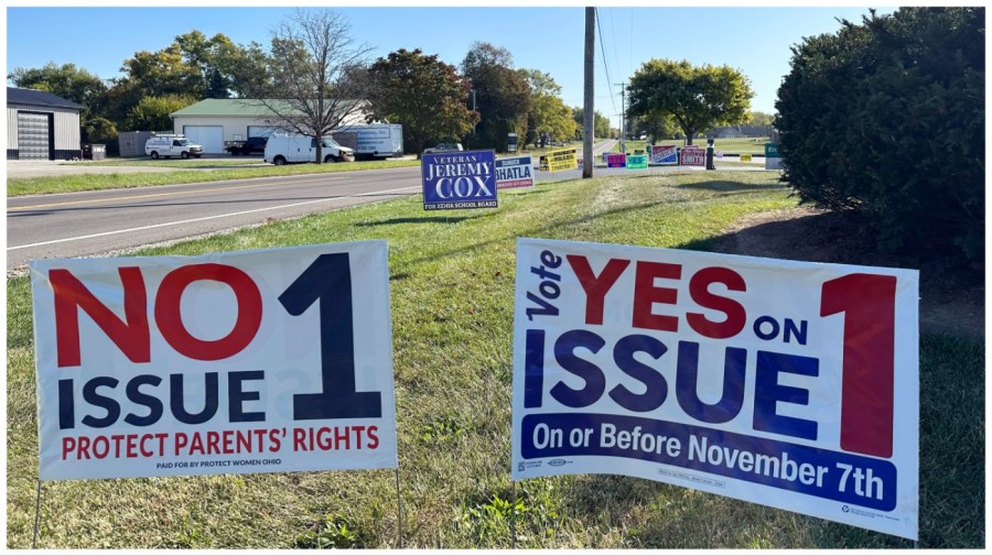 Signs for and against a proposed constitutional amendment to protect abortion rights in Ohio stand in front of the Greene County Board of Elections in Xenia, Ohio, Wednesday, Oct. 11, 2023, the first day of in-person voting. (AP Photo/Julie Carr Smyth)