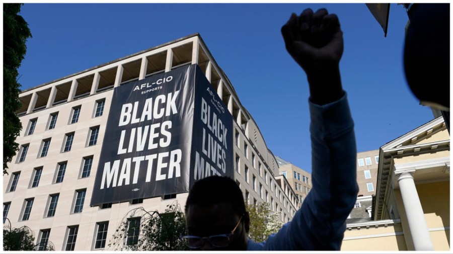 FILE - A person holds their fist in the air, April 20, 2021, in Washington at Black Lives Matter Plaza near the White House after the verdict in the murder trial against former Minneapolis police officer Derek Chauvin was announced in Minneapolis. On Tuesday, June 27, 2023, a California judge dismissed a civil lawsuit that grassroots racial justice activists from around the U.S. brought last summer against a foundation with stewardship of the Black Lives Matter movement’s charitable endowment worth tens of millions of dollars. (AP Photo/Alex Brandon, File)