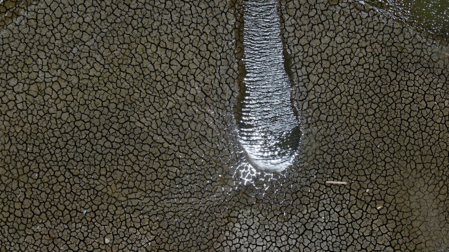 The Boca reservoir, that supplies water to the northern city of Monterrey, is almost dry as the northern part of Mexico is affected by an intense drought, in Santiago, Mexico, July 9, 2022. Tens of millions of people are being uprooted by natural disasters due to the impact of climate change, though the world has yet to fully recognize climate migrants or come up with a formalized mechanism to assess their needs and help them. (AP Photo/Fernando Llano, File)