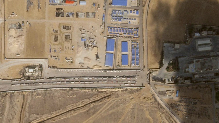 This satellite photo from Planet Labs PBC shows the Egyptian side of the Rafah border crossing where an aid convoy sat Thursday, Oct. 19, 2023. Satellite photos analyzed Friday, Oct. 20, 2023, by The Associated Press show a massive convoy of semitruck trailers lined up at the Rafah border crossing on the Egyptian side, likely waiting for approval to cross into the besieged Gaza Strip as the Israel-Hamas war rages.