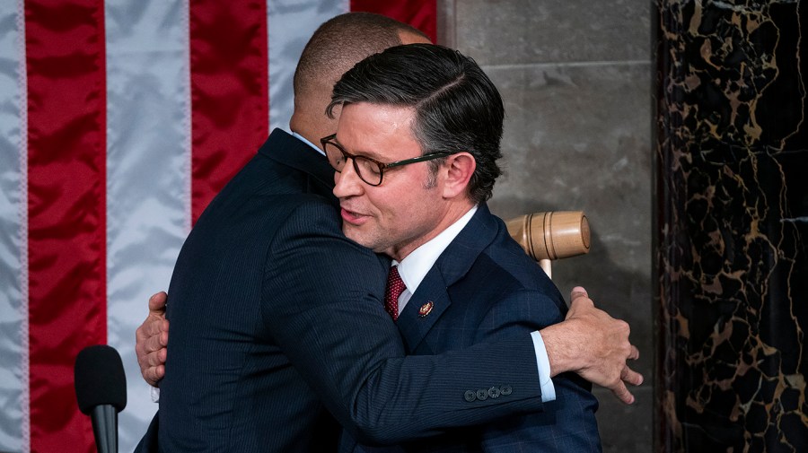 Minority Leader Hakeem Jeffries (D-N.Y.) hugs Speaker-elect Mike Johnson (R-La.)