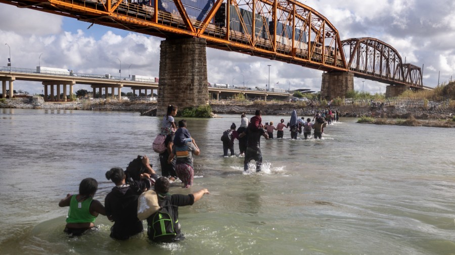 Asylum seekers cross the Rio Grande from Mexico into the United States on September 30, 2023 in Eagle Pass, Texas. Border security and immigration have become major issues in ongoing negotiations to fund the U.S. government.