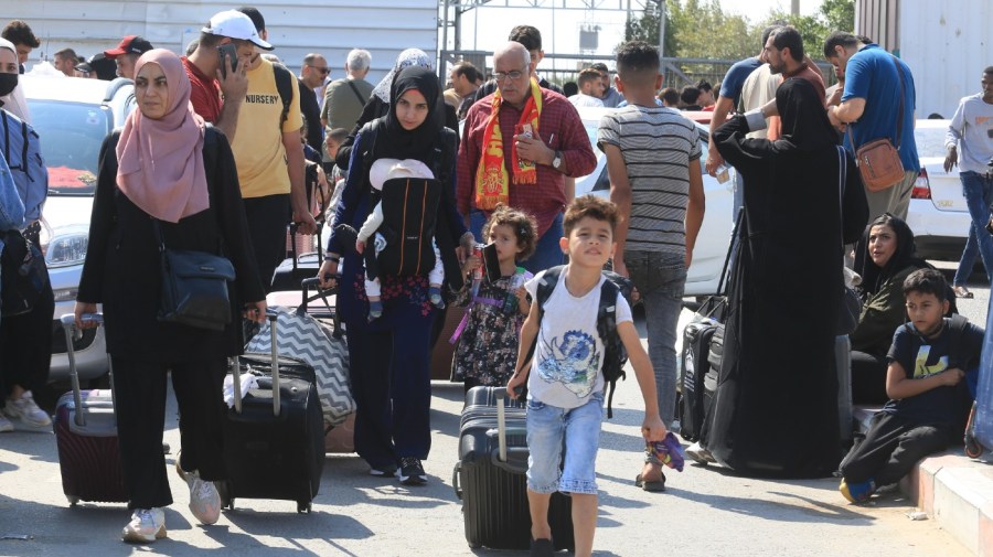 Palestinians wait at the Rafah border crossing between the Gaza Strip and Egypt Gaza Strip on Saturday, Oct. 14, 2023.