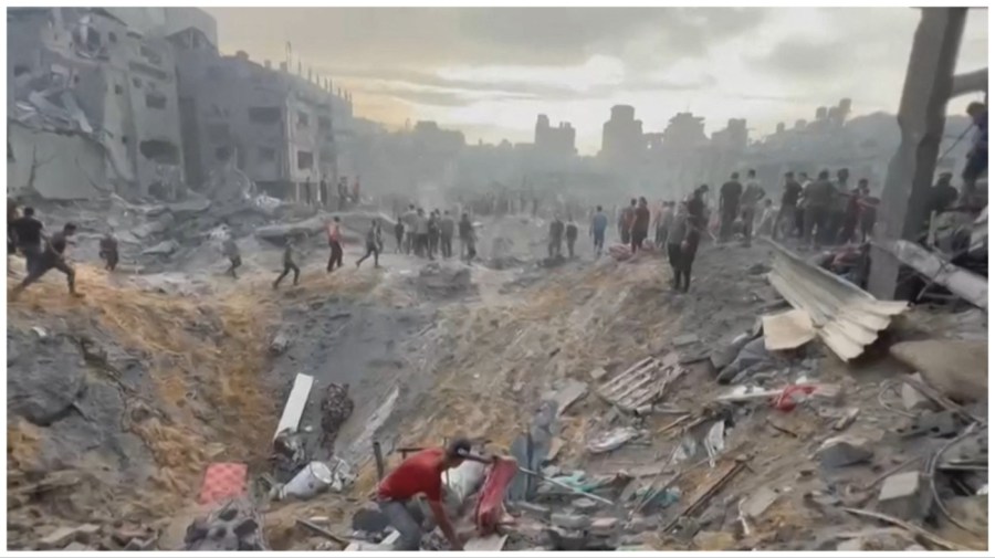 This image grab taken from AFPTV video footage shows Palestinians looking for survivors in a crater following a stike on a refugee camp in Jabalia on the northern Gaza Strip, on October 31, 2023, amid relentless Israeli bombardment of the Palestinian territory.