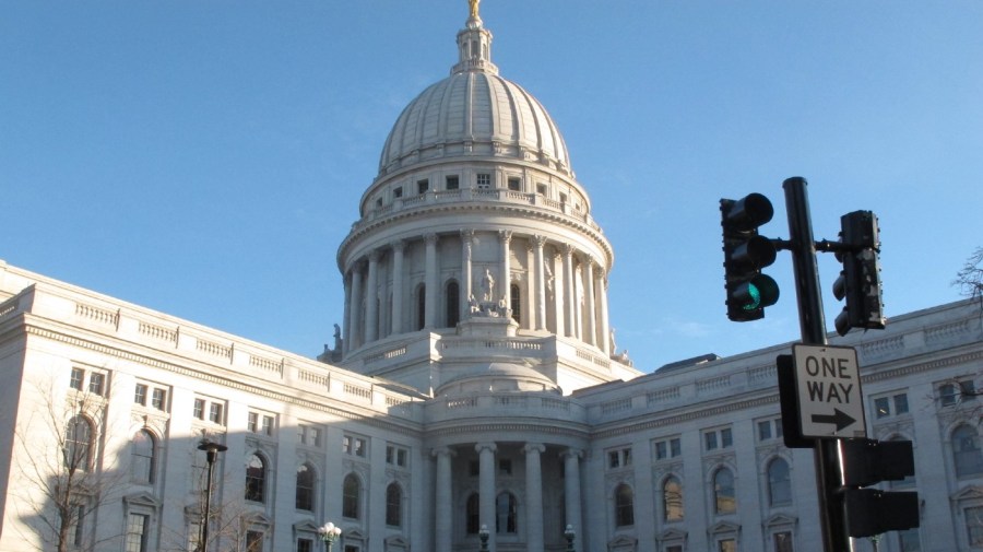 File - Police stand guard outside the Wisconsin state Capitol as they investigate the backpack of a person arrested after claiming to have a Molotov cocktail on Tuesday, Jan. 15, 2013, in Madison, Wis.