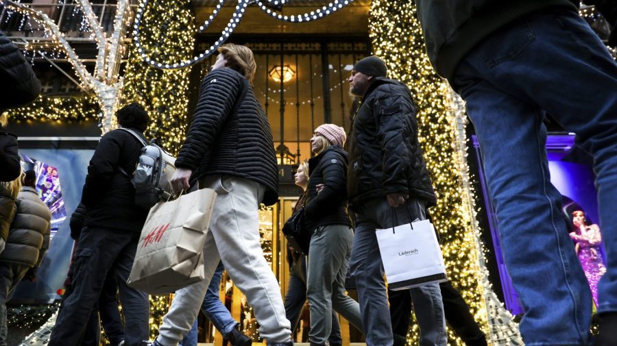 Shoppers carry shopping bags down Fifth Avenue in New York.