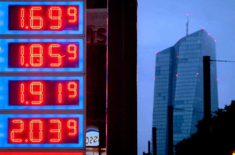 FILE - Gas prices are displayed at a gas station next to the headquarters of the European Central Bank, rear, in Frankfurt, Germany, on July 28, 2023. The inflation that has been wearing on European consumers fell sharply to 2.9% in October, its lowest in more than two years as fuel prices fell and rapid interest rate hikes from the European Central Bank took hold. (AP Photo/Michael Probst, File)