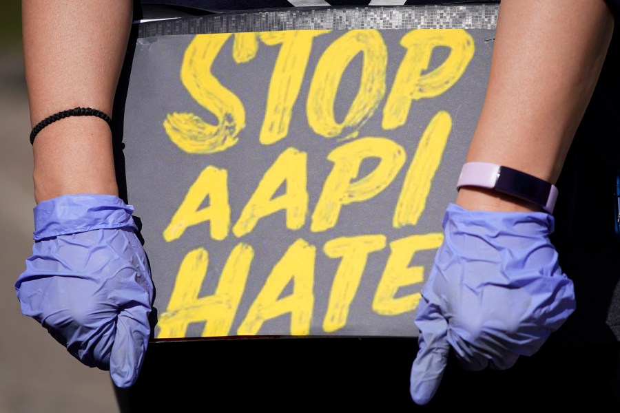 FILE - A person holds a sign and attends a rally to support stop AAPI (Asian Americans and Pacific Islanders) hate at the Logan Square Monument in Chicago, on March 20, 2021. Despite ongoing efforts to combat anti-Asian racism that arose after the pandemic, a third of Asian Americans and Pacific Islanders say they have experienced an act of abuse based on their race or ethnicity in the last year. (AP Photo/Nam Y. Huh, File)