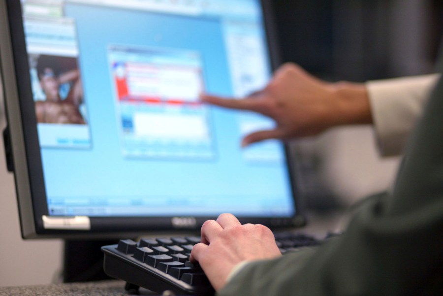 FILE - FBI Supervisory Special Agent Stacey Bradley and Special Agent "Jackie" of the Innocent Images Unit monitors possible child pornography offenders on May 4, 2006 in Calverton, Md. in an online chat room. European Union lawmakers adopted Tuesday, Nov. 14, 2023, a series of proposals to amend a bill from the EU’s executive arm to fight online child pornography as they tried to find the right balance between protecting children and protecting privacy. (AP Photo/Matt Houston)