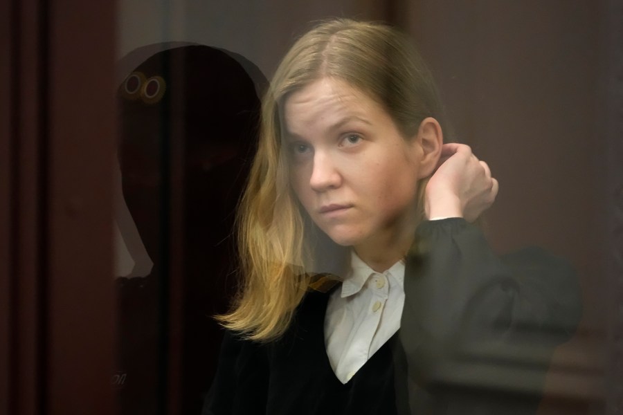 Darya Trepova, a suspect in a bombing that killed a well-known Russian military blogger, stands in a glass cage as she attends a court hearing in the 1st Western District Military Court, in St. Petersburg, Russia, Wednesday, Nov. 15, 2023. A military court in St Petersburg starts a trial against a 26-year-old woman Darya Trepova who is charged with terrorism after an attack at a St. Petersburg cafe that killed Russian military blogger Vladlen Tatarsky. (AP Photo/Dmitri Lovetsky)