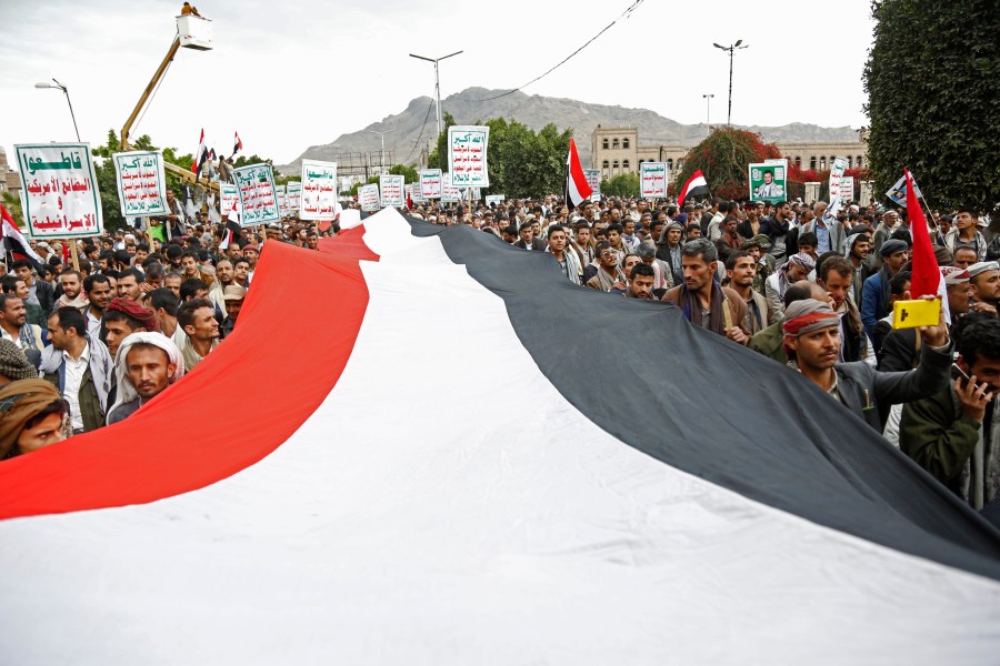 FILE - Houthi supporters chant slogans holding signs reading "Death to America, Death to Israel", as they attend a rally marking eight years for a Saudi-led coalition, Friday, March 26, 2023, in Sanaa, Yemen. For years, the Houthi rebels controlling northern Yemen have chanted slogans at their mass rallies calling for the destruction of Israel. But they never joined any conflict beyond the confines of their own country’s civil war or nearby in the Arabian Peninsula. The Iranian-backed Shiite Muslim force has launched at least six drone and missile attacks toward southern Israel since the Israel-Hamas war began on Oct. 7. (AP Photo/Hani Mohammed, File)