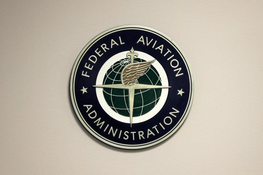 FILE - A Federal Aviation Administration sign hangs in the tower at John F. Kennedy International Airport, March 16, 2017, in New York. On Wednesday, Nov. 15, 2023, aviation experts who examined the FAA's safety record said the agency needs better staffing, equipment and technology to cope with a surge in the most serious close calls between planes. (AP Photo/Seth Wenig, File)