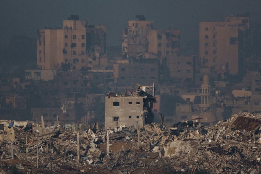 Destroyed buildings are seen in the Gaza Strip, as seen from southern Israel, Monday, Nov. 20, 2023. (AP Photo/Leo Correa)