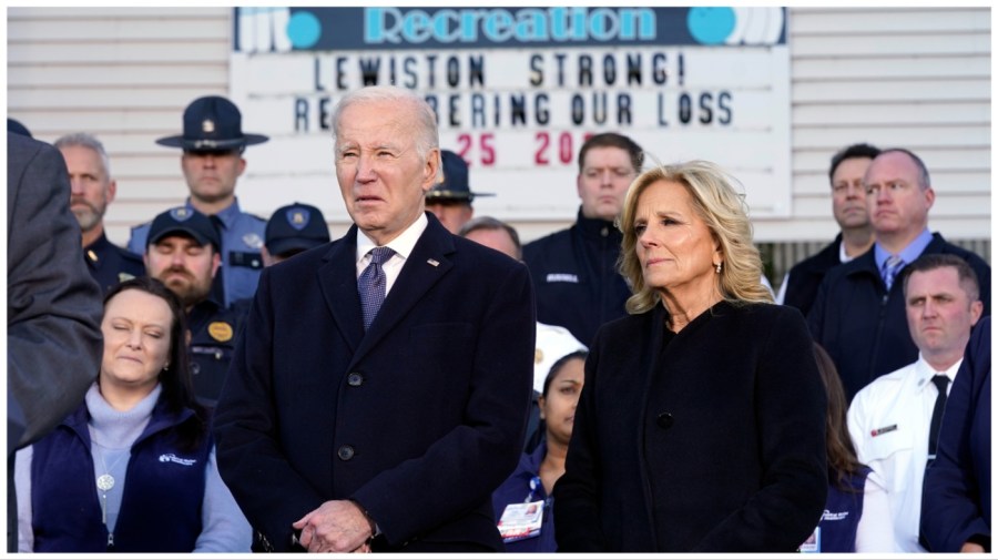 President Joe Biden, with first lady Jill Biden, listens outside of Just-In-Time Recreation before he speaks Friday, Nov. 3, 2023, in Lewiston, Maine, about the mass shooting last week. (AP Photo/Evan Vucci)