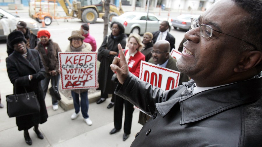 Dr. Tony Minor, right, speaks before a march Tuesday, April 4, 2006 in Cleveland.