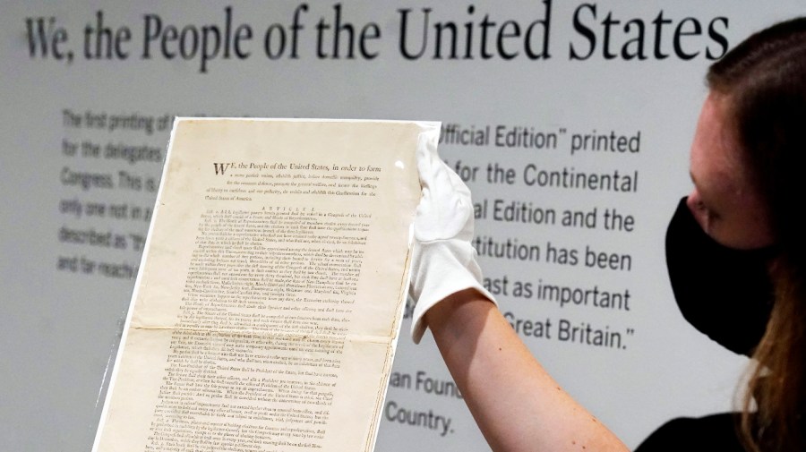 Ella Hall, a specialist in Books and Manuscripts at Sotheby's, in New York, holds a 1787 printed copy of the U.S. Constitution, Sept. 17, 2021.