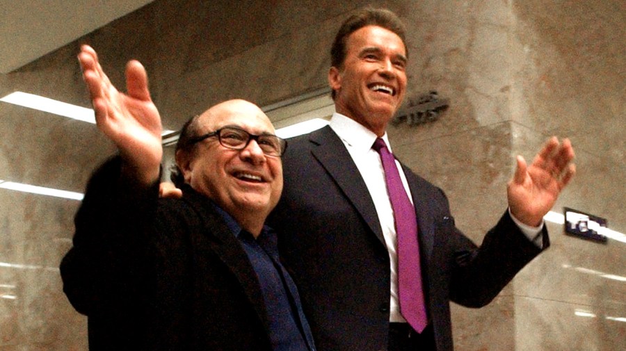 FILE - In this April 15, 2004 file photo, actor Danny DeVito, left, waves as he walks through the state capitol with long-time friend, movie co-star then-governor of California, Arnold Schwarzenegger, in Sacramento, Calif. 