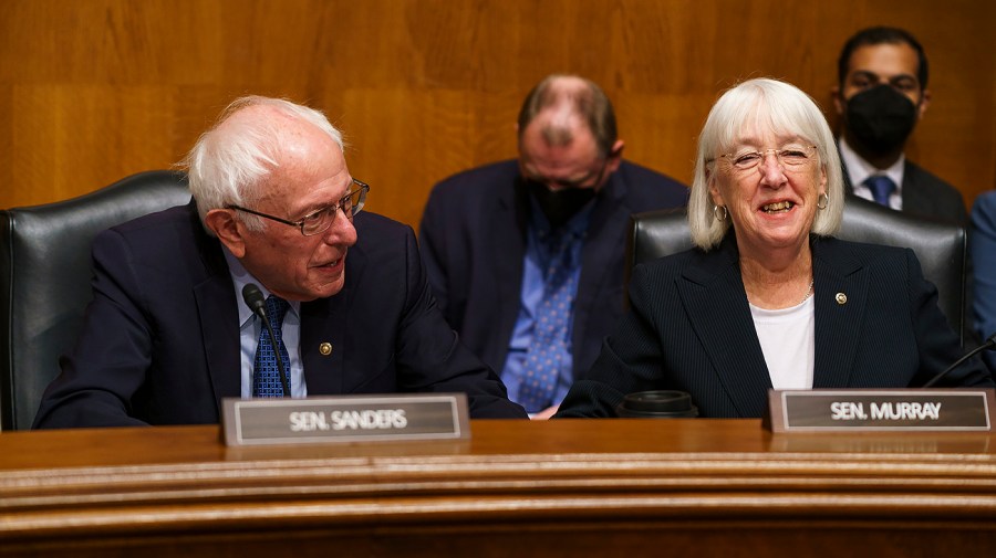 Senate Health, Education, Labor and Pensions Committee Chair Bernie Sanders and Senator Patty Murray (D-Wash.) are seated next to each other at a committee meeting.